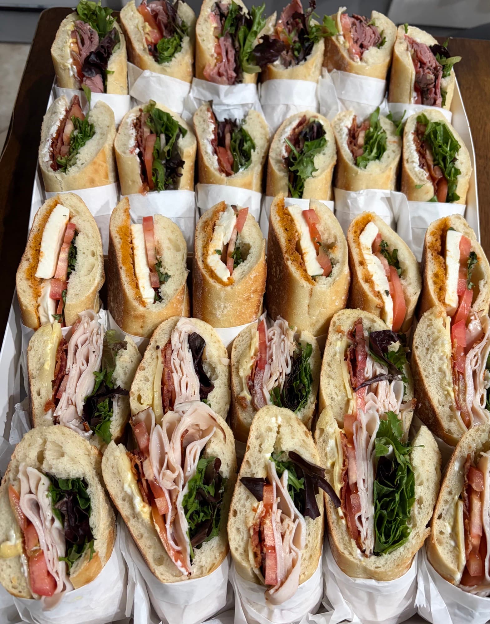 Rows of fresh baguette sandwiches stacked high