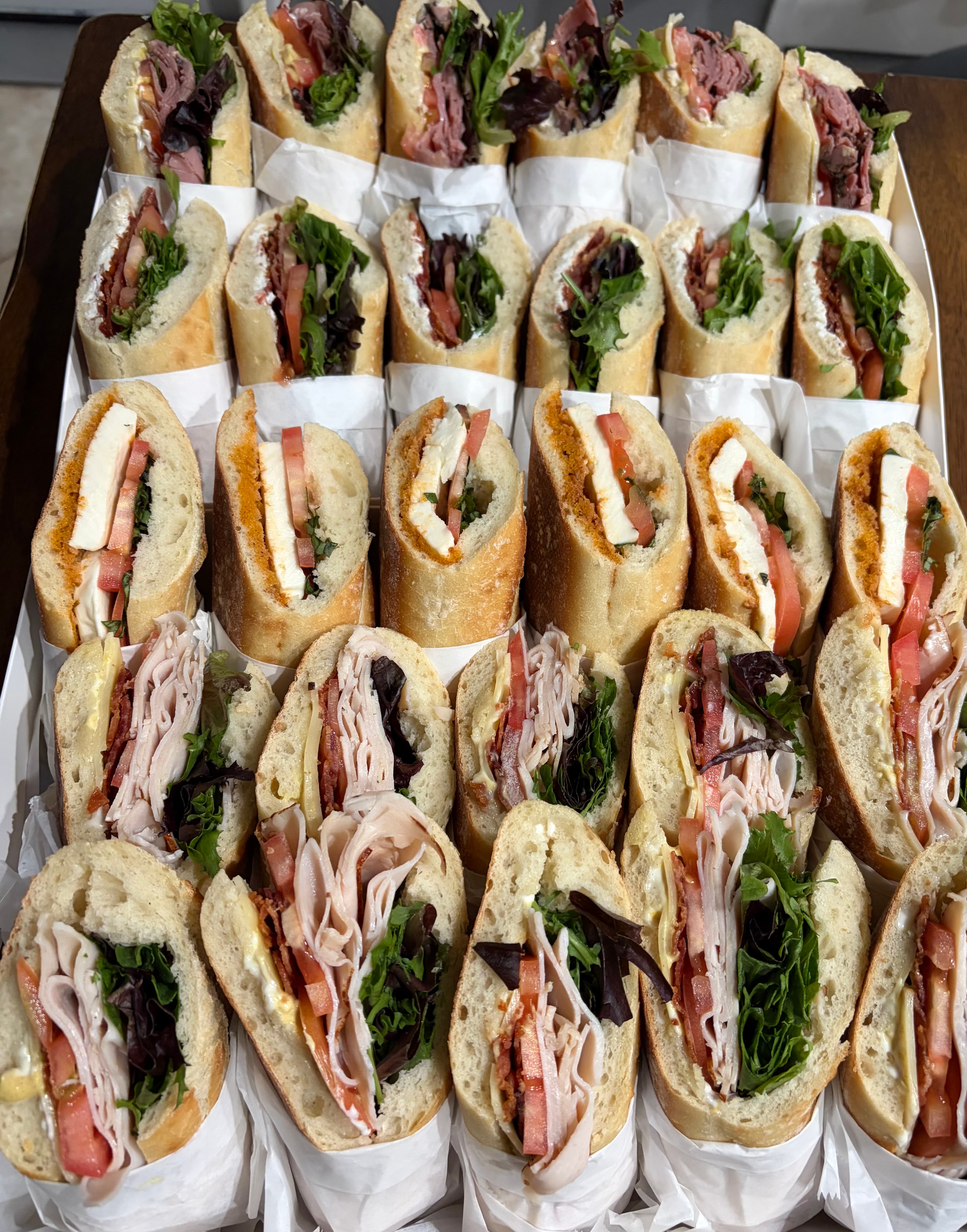 Rows of fresh baguette sandwiches stacked high